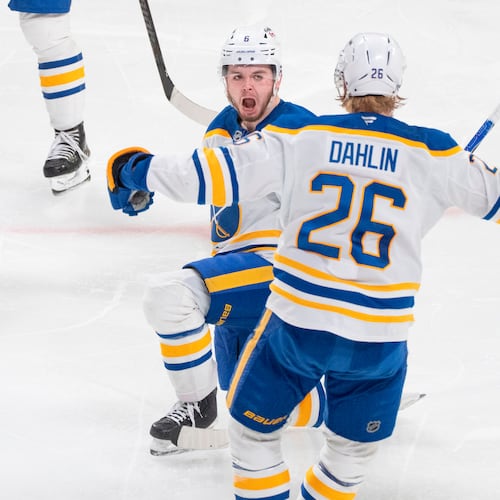 Buffalo Sabres' Zach Benson (6) celebrates his goal over Montreal Canadiens with teammate Rasmus Dahlin (26) during third period, second round, game 4, NHL playoff action in Montreal on Tuesday, May 12, 2026. (Christinne Muschi/The Canadian Press via AP)