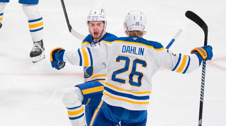 Buffalo Sabres' Zach Benson (6) celebrates his goal over Montreal Canadiens with teammate Rasmus Dahlin (26) during third period, second round, game 4, NHL playoff action in Montreal on Tuesday, May 12, 2026. (Christinne Muschi/The Canadian Press via AP)