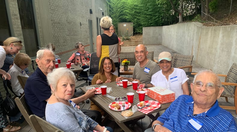 Whitney Oeltmann (kneeling) created a foundation that focuses on education, care and support for those diagnosed with Alzheimer's and dementia.