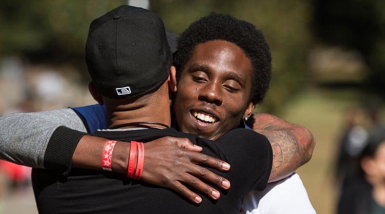 LaMar Yarborough greets a friend while volunteering at the 25th Annual AIDS Walk Atlanta & 5K Run in Piedmont Park Sunday, October 18, 2015.