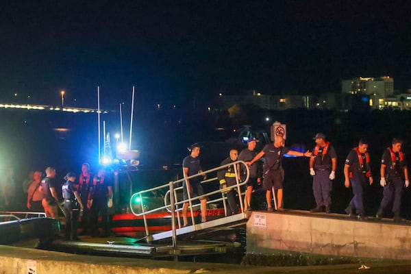 Rescue workers gather at the Seminole Boat ramp north of where a boat crashed into the ferry causing multiple injuries near the Clearwater Memorial Causeway Bridge, on Sunday, April 27, 2025, in Clearwater, Fla. (Douglas R. Clifford/Tampa Bay Times via AP)