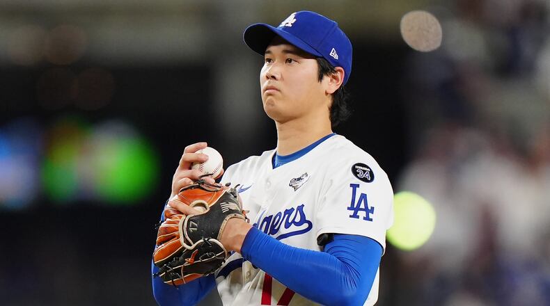 Los Angeles Dodgers pitcher Shohei Ohtani (17) reacts after giving up a double during seventh inning Game 4 World Series playoff MLB baseball action against the Toronto Blue Jays in Los Angeles on Tuesday, Oct. 28, 2025. (Frank Gunn/The Canadian Press via AP)