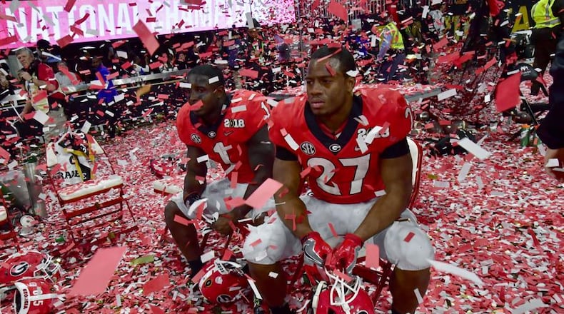 Georgia running back Sony Michel, left and Georgia running back Nick Chubb are despondent after Alabama's win Monday night. AJC photo: Hyosub Shin