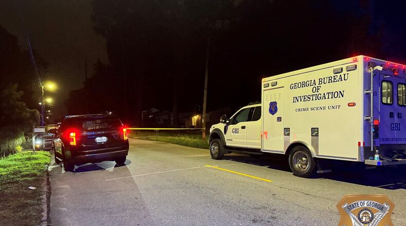 The GBI is investigating after a Fulton County sheriff's deputy shot a man suspected of driving a stolen SUV and then brandishing a gun after being pulled over late Tuesday.