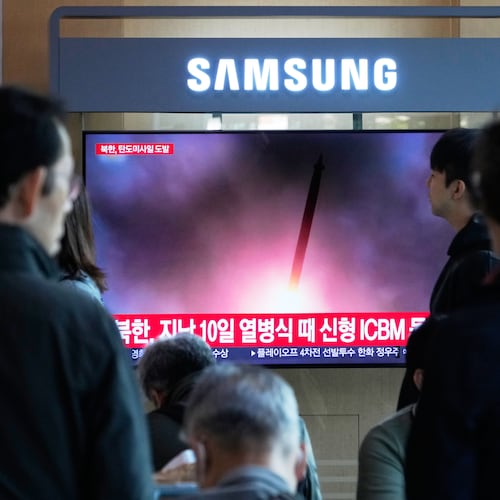 A TV screen shows a file image of North Korea's missile launch during a news program at Seoul Railway Station in Seoul, South Korea, Wednesday, Oct. 22, 2025. (AP Photo/Ahn Young-joon)