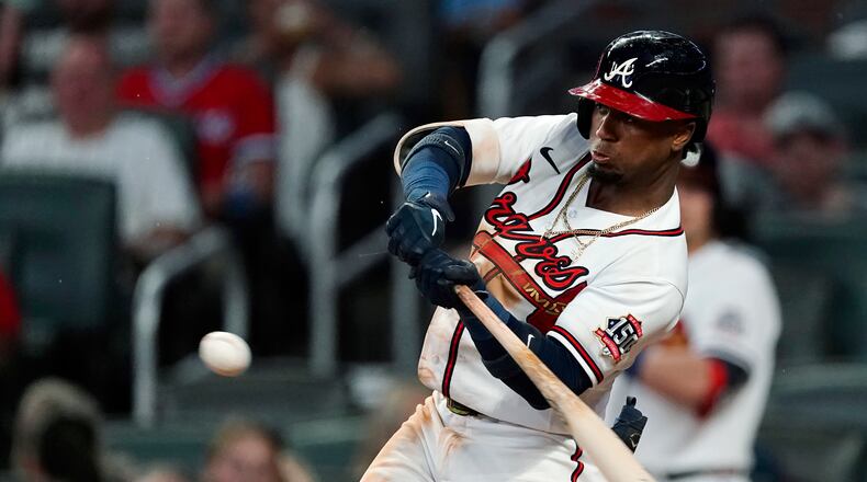 Atlanta Braves' Ozzie Albies hits a single during the third inning of the team's baseball game against the New York Mets on Wednesday, June 30, 2021, in Atlanta. (AP Photo/John Bazemore)