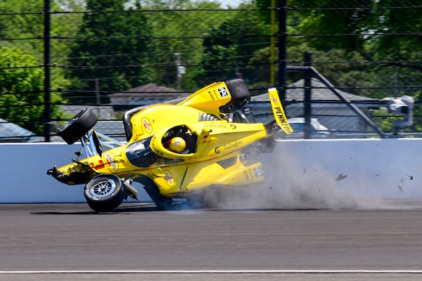 The car driven by Scott McLaughlin, of New Zealand, becomes airborne after hitting the wall in the second turn during practice for the Indianapolis 500 auto race at Indianapolis Motor Speedway in Indianapolis, Sunday, May 18, 2025. (AP Photo/John Maxwell)