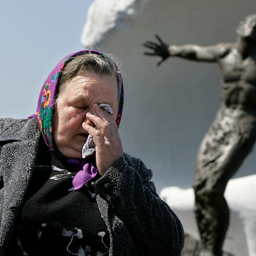 FILE – Tatyana Ignatenko, the mother of firefighter Vasily Ignatenko, grieves near his grave at Mitinskoye Cemetery in Moscow, Russia, on Wednesday, April 26, 2006, the 20th anniversary of the explosion and fire at the Chernobyl nuclear power plant in Ukraine. Vasily Ignatenko's crew was the first to respond to the disaster. (AP Photo/Alexander Zemlianichenko, File)