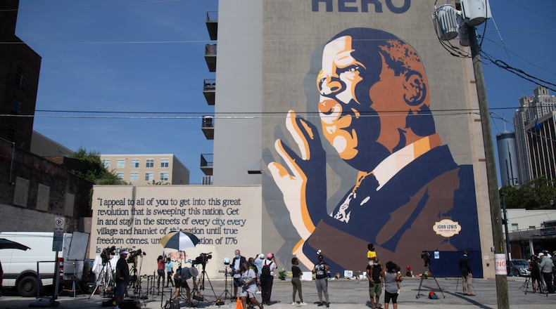 People gather in front of the large John Lewis mural on Auburn Avenue in Atlanta on Saturday, July 18, 2020, to pay their respects to the civil rights icon who died the night before. (Photo: Steve Schaefer for The Atlanta Journal-Constitution)
