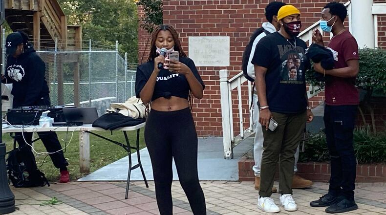 Clark Atlanta University senior Alivia Duncan reads a list of demands from Atlanta University Center students to their schools and federal officials for better housing and student loan debt relief. (Eric Stirgus/eric.stirgus@ajc.com.)