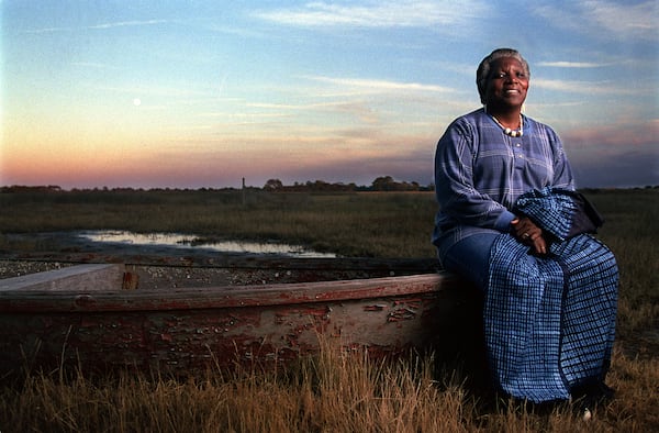 Cornelia Bailey sits on a bateau on the edge of a Sapelo Island salt marsh. This bateau is one of the two traditional handmade Geechee boats that still survives on the island. (Ben Gray for the AJC 2021)