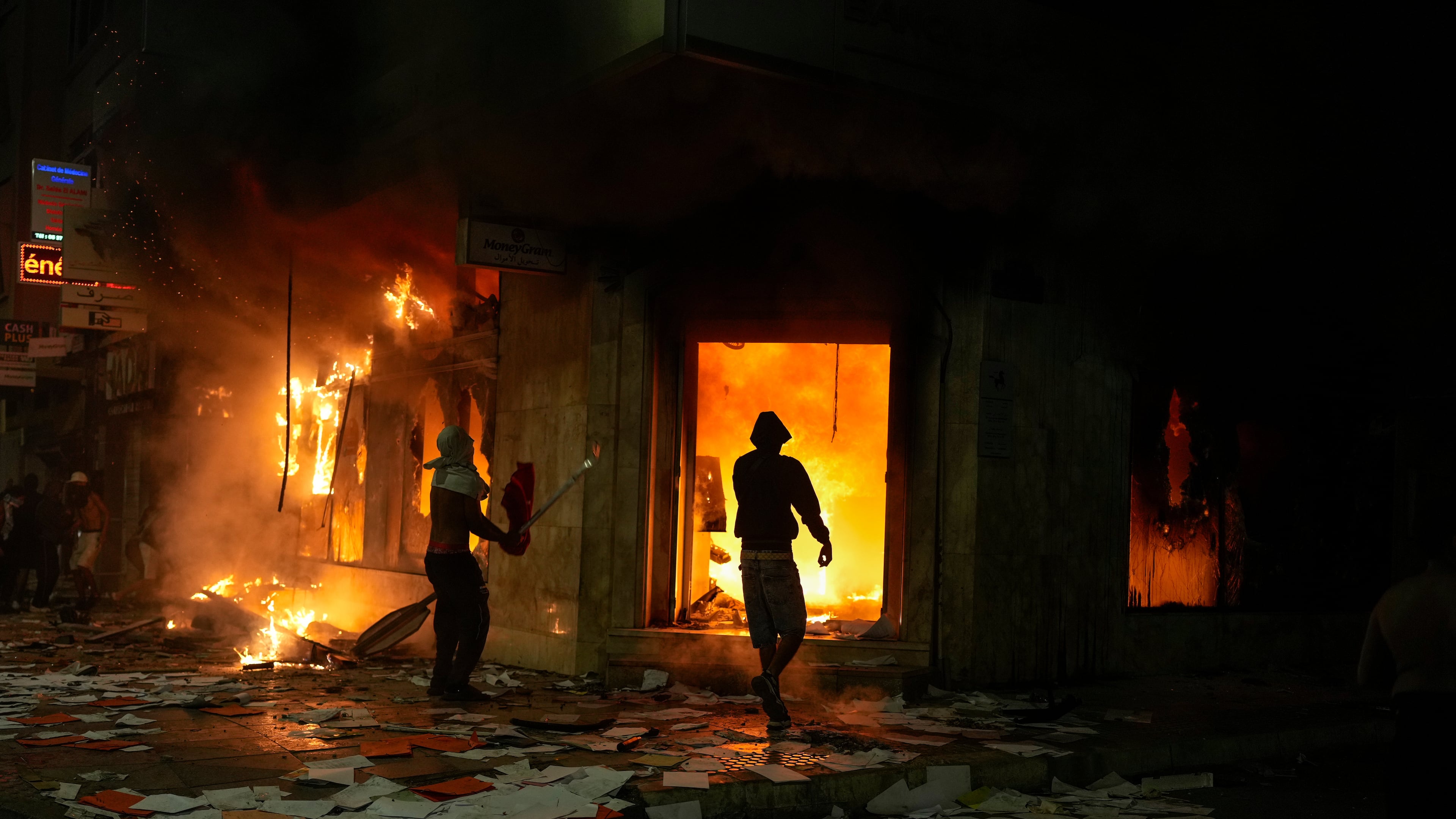 People torch and loot a bank as youth led protests calling for healthcare and education reforms turned violent, in Sale, Morocco, Wednesday, Oct. 1, 2025. (AP Photo/Mosa'ab Elshamy)