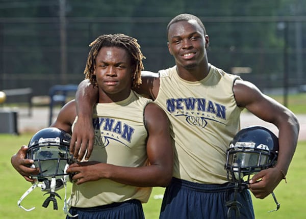 Alexander “Zander” Ogletree (left), shown with his brother Alec Ogletree during their high school playing days, has been coaching high school football since 2015. (Jason Getz/AJC 2009)