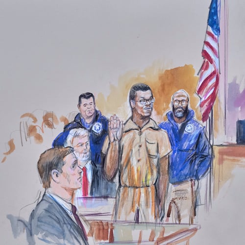 This courtroom sketch depicts Brian Cole Jr., 30, of Woodbridge, Va., the man accused of planting a pair of pipe bombs outside the headquarters of the Republican and Democratic national parties on Jan. 5, 2021, in Washington, being sworn in, Friday, Dec. 5, 2025 before U.S. Magistrate Moxila Upadhyaya, at Federal Court in Washington, as U.S. Attorney Charles Jones, seated left, and Defense Attorney John Shoreman, seated center, look on. (Dana Verkouteren via AP)