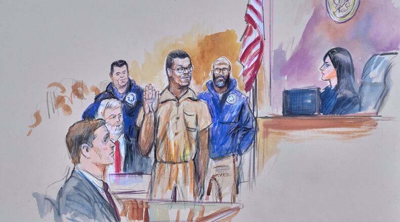 This courtroom sketch depicts Brian Cole Jr., 30, of Woodbridge, Va., the man accused of planting a pair of pipe bombs outside the headquarters of the Republican and Democratic national parties on Jan. 5, 2021, in Washington, being sworn in, Friday, Dec. 5, 2025 before U.S. Magistrate Moxila Upadhyaya, at Federal Court in Washington, as U.S. Attorney Charles Jones, seated left, and Defense Attorney John Shoreman, seated center, look on. (Dana Verkouteren via AP)