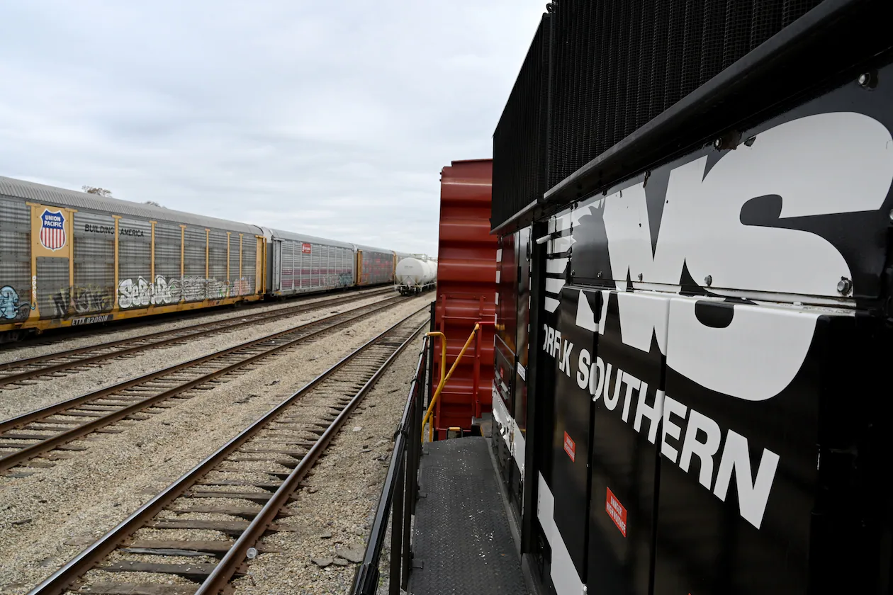 Norfolk Southern’s ‘Safety Train’ (right) makes a stop in East Point across the tracks from a Union Pacific railcar, Wednesday, March 24, 2026, in Atlanta. Union Pacific is working to acquire Norfolk Southern, pending federal regulatory approval. (Hyosub Shin/AJC)