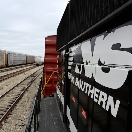 Norfolk Southern’s ‘Safety Train’ (right) makes a stop in East Point across the tracks from a Union Pacific railcar, Wednesday, March 24, 2026, in Atlanta. Union Pacific is working to acquire Norfolk Southern, pending federal regulatory approval. (Hyosub Shin/AJC)