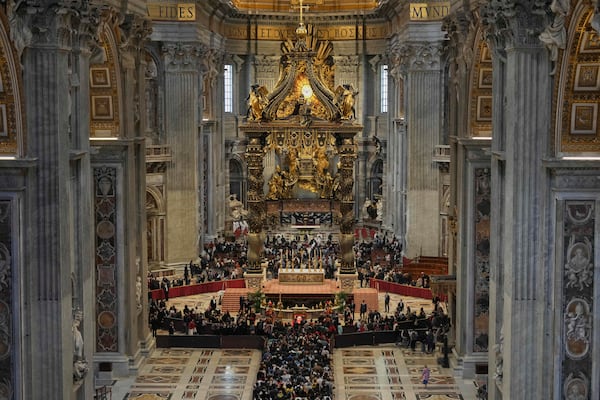 People line up to pay their respects to Pope Francis lying in state, inside St. Peter's Basilica, at the Vatican, Friday, April 25, 2025. (AP Photo/Andrew Medichini)