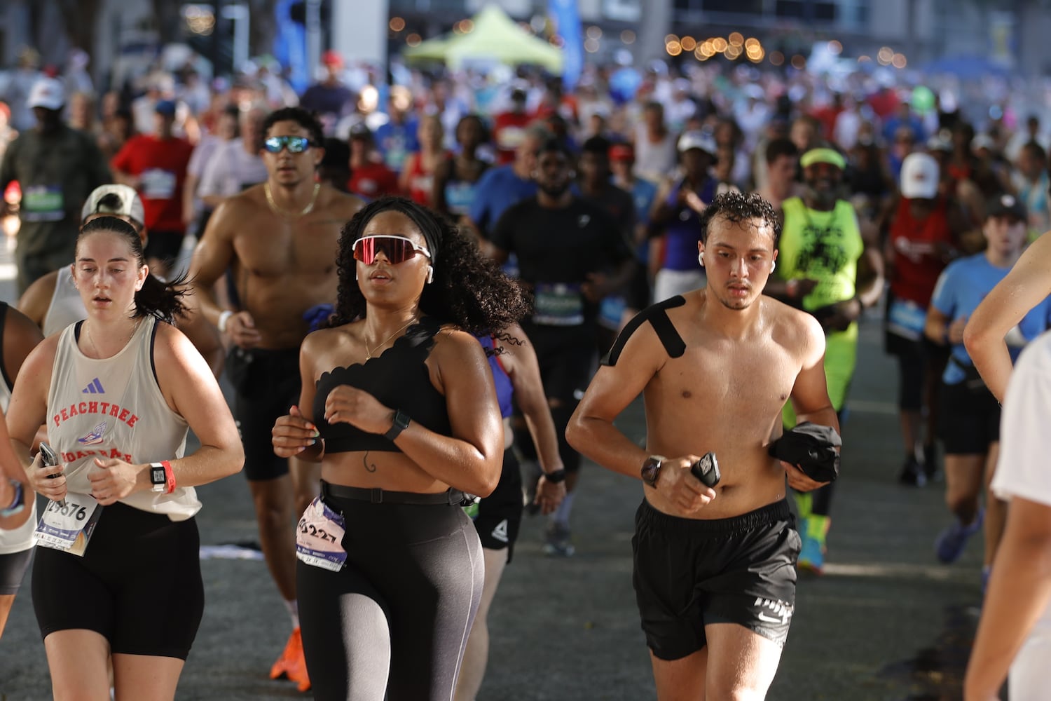 Runners approach the turn to the Piedmont Street finish line at  the 56th running of the Atlanta Journal-Constitution Peachtree Road Race in Atlanta on Friday, July 4, 2025.   (Natrice Miller / AJC)