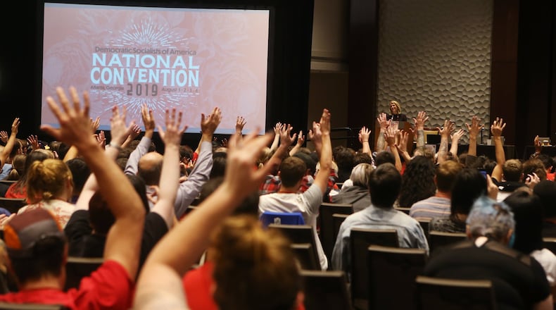 Delegates raise their hands in the American Sign Language sign for applause for speaker Sara Nelson, international president of the Association of Flight Attendants, during the Democratic Socialists of America National Convention at the Westin Hotel in Atlanta on Friday, August 2, 2019. (Photo; Christina Matacotta/Christina.Matacotta@ajc.com)