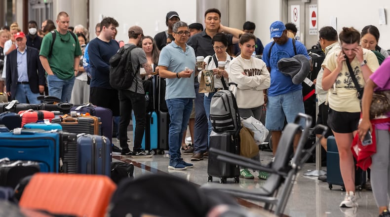 The Delta Baggage Service saw long lines Monday morning and clusters of passengers sleeping on backpacks and folded blankets were spread throughout the Hartsfield-Jackson International Airport domestic terminal Monday morning, July 22, 2024. By Monday morning, travel disruptions caused by a flawed cybersecurity update showed that Hartsfield-Jackson had the most flights canceled on Monday out of the airports FlightAware tracks. (John Spink/AJC)