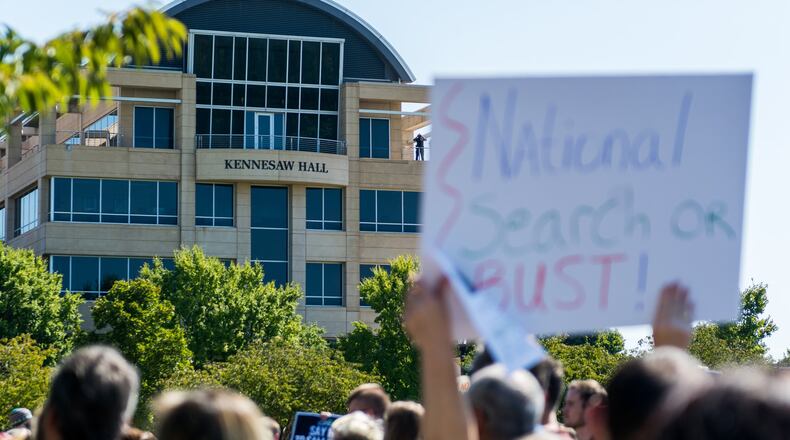 Protesters gather on Oct. 3 on The Green in front of Kennesaw Hall to protest the recent proposal to consider Attorney General Sam Olens as KSU’s next president. (AJC/Cory Hancock)