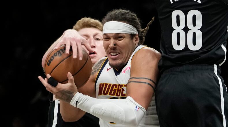 Brooklyn Nets forward Danny Wolf, left, steals the ball from Denver Nuggets forward Aaron Gordon during the second half of an NBA basketball game, Sunday, Jan. 4, 2026, in New York. (AP Photo/Yuki Iwamura)