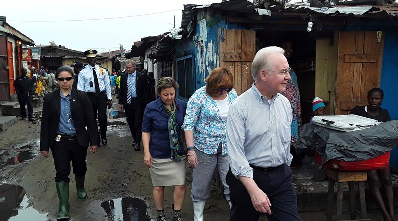 US Secretary of Health and Human Services Tom Price, right, walks Thursday May 18, 2017 through a densely-populated and heavily congested Monrovia, Liberia, slum community which was quarantined in 2014 when Ebola struck there killing dozens. This is Price's first visit outside the US since assuming the position. (AP Photo/Jonathan Paye-Layleh)