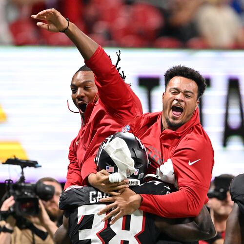 Falcons running back Nathan Carter celebrates with teammates after scoring a touchdown against the Tennessee Titans during an NFL preseason game at Mercedes-Benz Stadium on Friday, Aug. 15, 2025, in Atlanta. The Falcons will play the Cowboys on Friday at AT&T Stadium in Arlington, Texas. (Hyosub Shin/AJC)