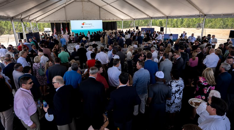 People gather under a tent on Friday, May 20, 2022 for an announcement at the site where South Korean automotive giant Hyundai Motor Group will build an electric vehicle plant in Ellabell, Ga. It is the second major electric vehicle factory announcement in Georgia since December as state economic development officials try to turn the Peach State into an important manufacturing hub for battery-powered automobiles. (AJC Photo/Stephen B. Morton)
