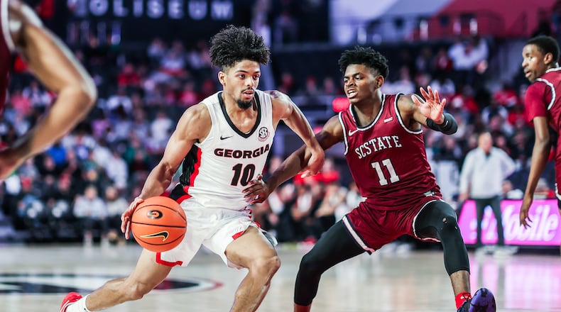 Georgia point guard Aaron Cook (10) dribbles past South Carolina State's Rakeim Gary during their Division I college basketball game Tuesday, Nov. 16, 2021, at UGA's Stegeman Coliseum. (Photo by Mackenzie Miles/UGA Athletics)