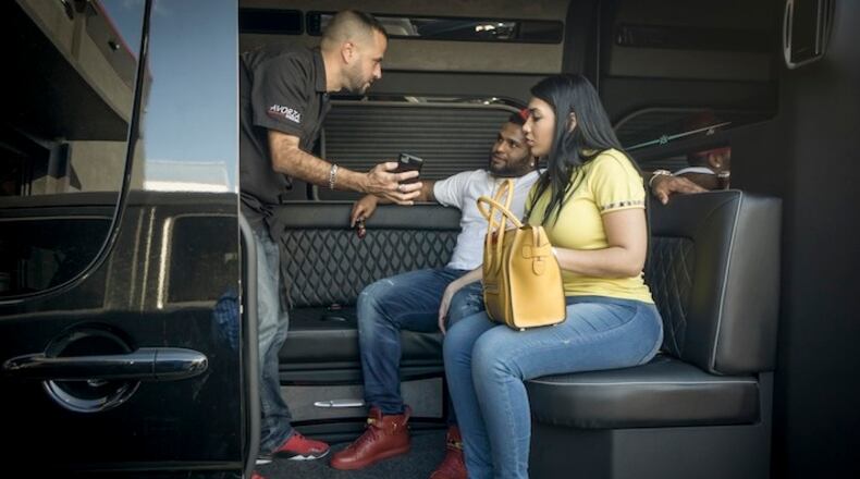 Alex Vega, left, owner of The Auto Firm, a car customizing and restoring shop with a vast clientele of professional athletes, shows Pablo Sandoval of the Red Sox and Yulimar Martins a customized Mercedes Benz limo van in Doral, Fla., Dec. 11, 2015. If major league stars want reclining chairs, wraparound leather couches and big-screen televisions in their vehicles, they know where to go. (Angel Valentin/The New York Times)