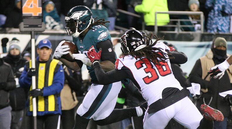 January 13, 2018 Philadelphia: Eagles running back LeGarrette Blount scores a touchdown past Falcons safety Kemal Ishmael for a 6-3 lead during the first half in their NFC Divisional Game on Saturday, January 13, 2018, in Philadelphia. Curtis Compton/ccompton@ajc.com