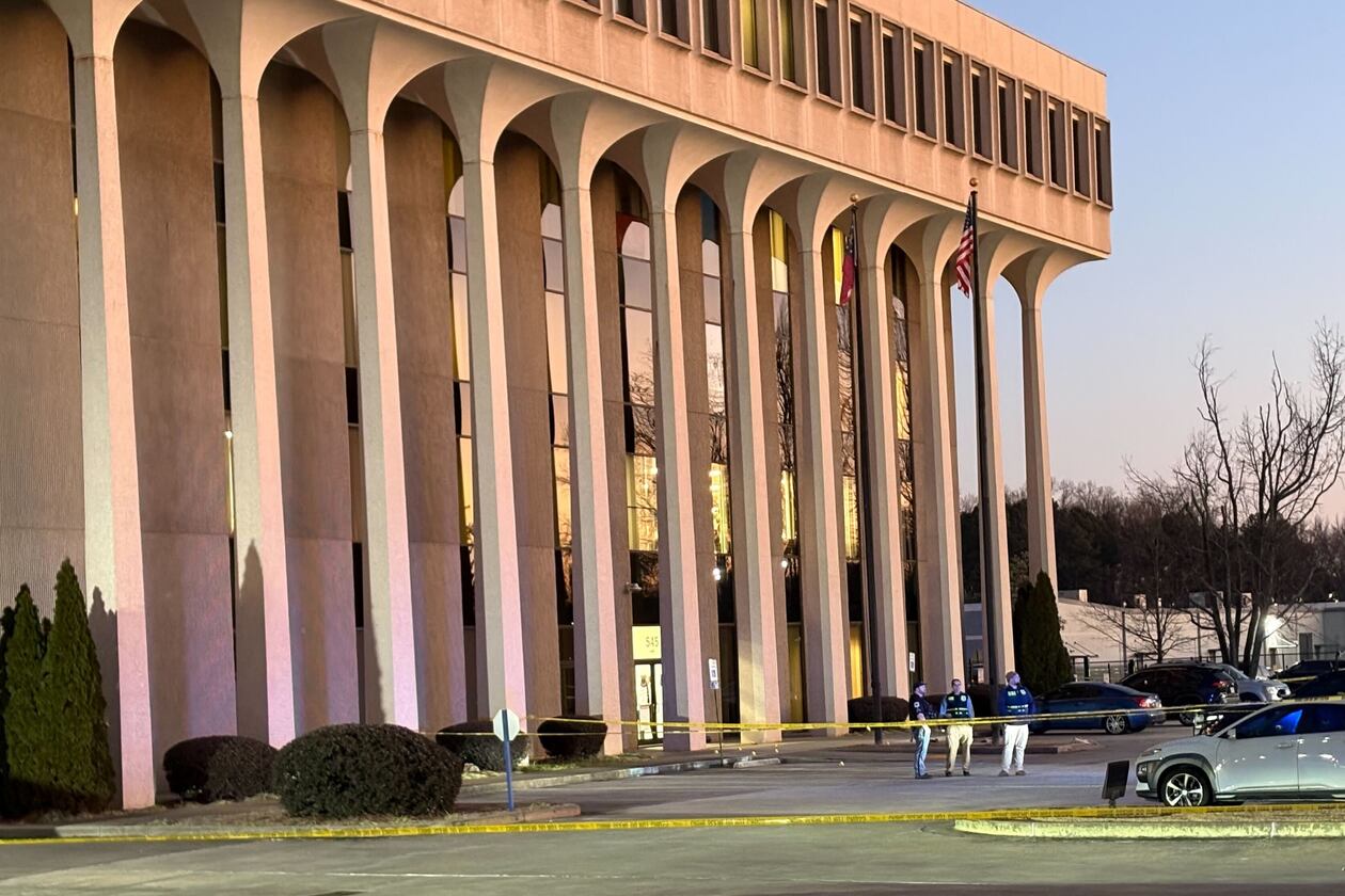 The front parking lot of Cobb County police headquarters was taped off and GBI officials were at the scene Wednesday, Jan. 28, 2026. (Alexis Stevens/AJC)