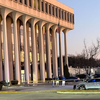 The front parking lot of Cobb County police headquarters was taped off and GBI officials were at the scene Wednesday, Jan. 28, 2026. (Alexis Stevens/AJC)
