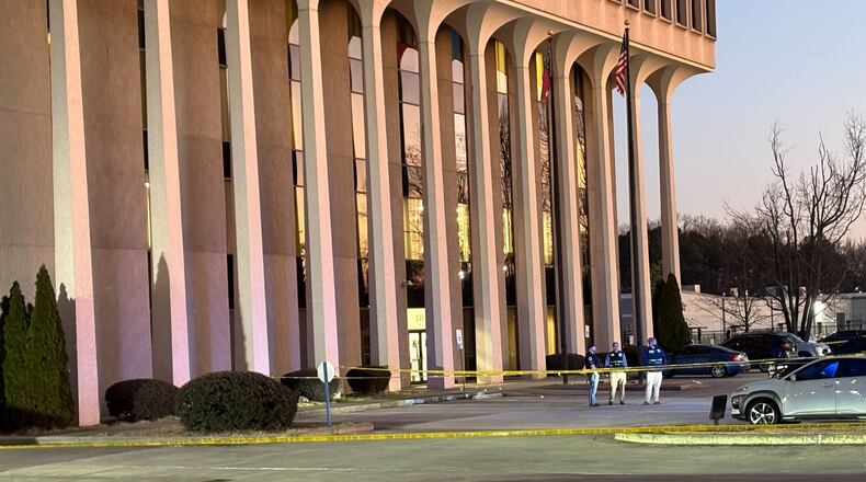 The front parking lot of Cobb County police headquarters was taped off and GBI officials were at the scene Wednesday, Jan. 28, 2026. (Alexis Stevens/AJC)