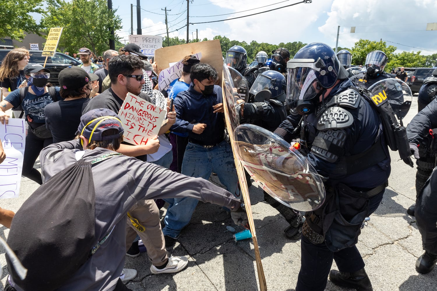 Police advance on demonstrators during a protest on ICE raids and deportation arrests on Chamblee Tucker Road in Atlanta on Saturday, June 14, 2025. (Arvin Temkar / AJC)