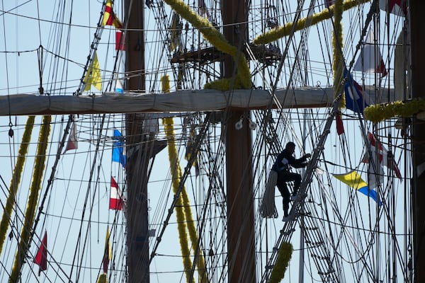 A person climbs up the rigging of the Cuauhtemoc, a masted Mexican Navy training ship, at Pier 35 after it collided with the Brooklyn Bridge in New York, Monday, May 19, 2025. (AP Photo/Seth Wenig)