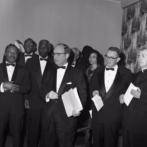 From left, the Rev. Martin Luther King Jr., Morehouse College President Benjamin E. Mays, Rabbi Jacob Rothschild, Atlanta Constitution editor Ralph McGill (in glasses) and Catholic Archbishop Paul Hallinan attend the Nobel Peace Prize recognition dinner honoring King in Atlanta on Jan. 27, 1965. (Credit: LBSCB12-120g, Lane Brothers Commercial Photographers Photographic Collection, 1920-1976. Special Collections and Archives, Georgia State University Library)