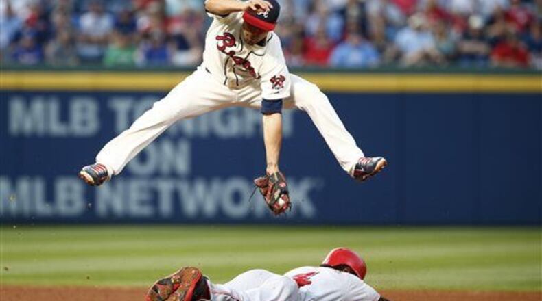 Jace Peterson, here avoiding a slide by the Reds' Brandon Phillips, has played solid defense and raise his average above .290 with a 15-game surge. (AP photo)