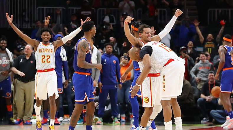 Atlanta Hawks guard Vince Carter, playing in what may be the final game of his career with the season being suspended by the NBA, gives Trae Young a hug after hitting a 3-pointer for the final shot of the game during a 136-131 overtime loss to the New York Knicks in a NBA basketball game. Curtis Compton ccompton@ajc.com