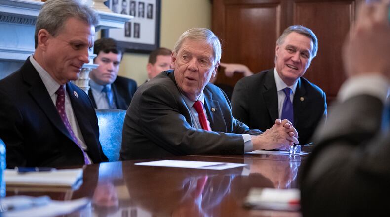 U.S. Sen. Johnny Isakson, R-Ga., is flanked by U.S. Rep. Buddy Carter R-Pooler, left, and U.S. Sen. David Perdue, R-Ga. All three have expressed their opposition to the impeachment inquiry against President Donald Trump. (AP Photo/J. Scott Applewhite)