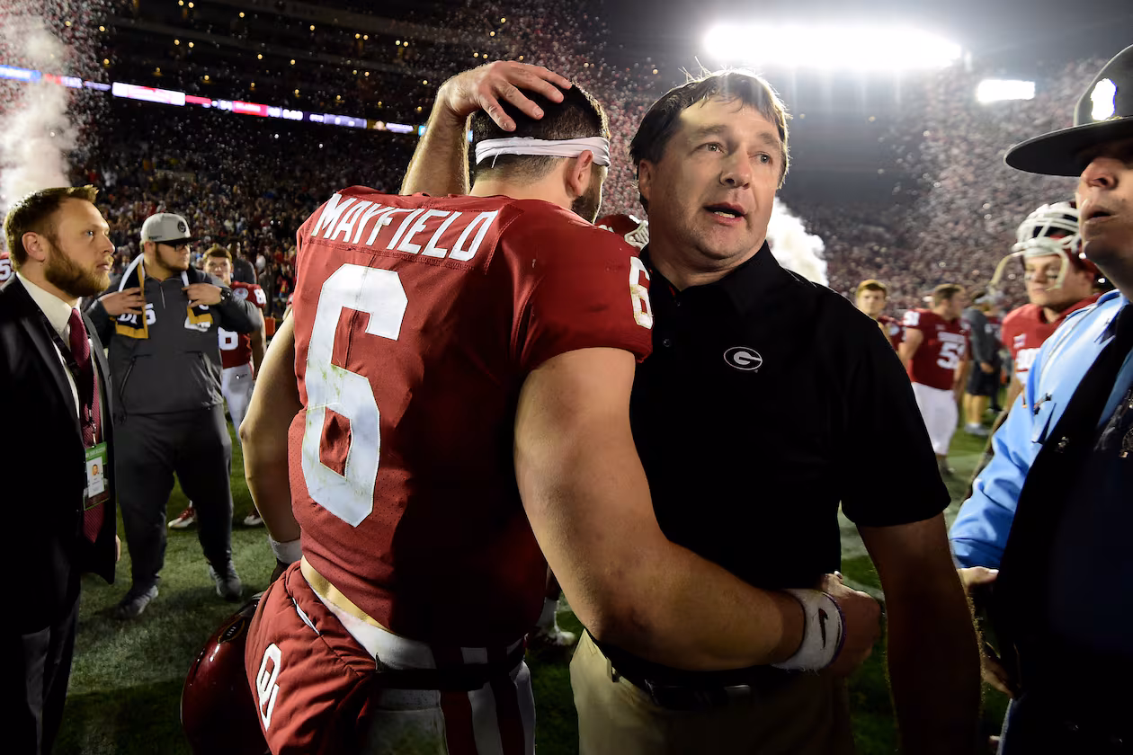 Head Coach Kirby Smart of the Georgia Bulldogs hugs quarterback Baker Mayfield of the Oklahoma Sooners after the Bulldogs beat the Oklahoma Sooners 54-48 in double overtime in the 2018 College Football Playoff Semifinal Game at the Rose Bowl Game presented by Northwestern Mutual at the Rose Bowl on Jan. 1, 2018, in Pasadena, California. (Courtesy of Harry How)