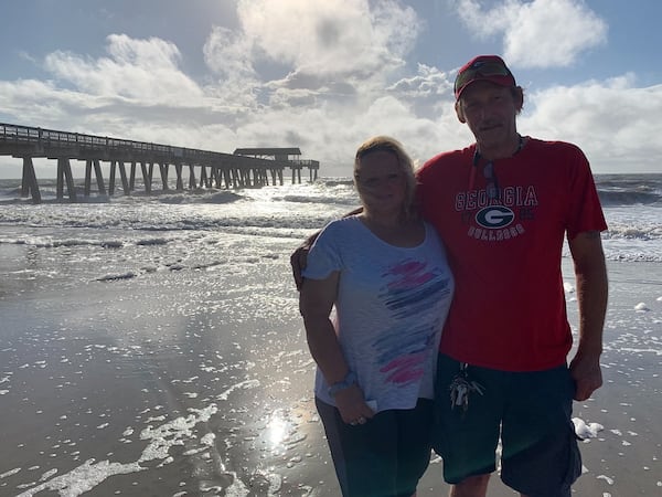 Bennie and Tammy Watkins of Calhoun were among some visitors who remained on Tybee Island Tuesday, feeding bread to the seagulls and snapping photos. The island vacation was a surprise birthday gift for her. They got here Sunday morning and are planning to leave ahead of the storm Wednesday. JEREMY REDMON/jredmon@ajc.com