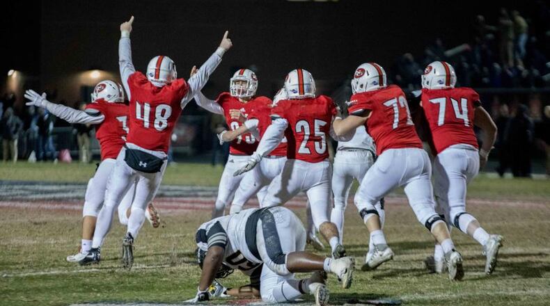 North Gwinnett High School players celebrate after kicker Cameron Clark (93) kicked the game winning field goal against Colquitt High School during a Class AAAAAAA football championship game, Friday, Dec. 15, 2017, in Suwanee.