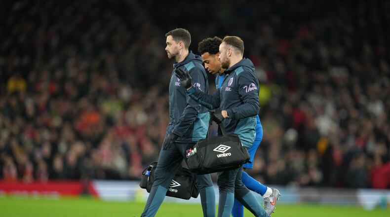 Bournemouth's Tyler Adams is helped off the pitch during a Premier League soccer match between Manchester United and Bournemouth in Manchester, England, Monday, Dec. 15, 2025. (AP Photo/Jon Super)