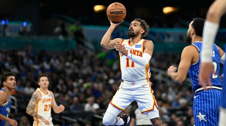 Atlanta Hawks guard Trae Young (11) goes up to shoot in front of Orlando Magic guard Tyus Jones (2) during the first half of an NBA basketball game Friday, Oct. 24, 2025, in Orlando, Fla. (AP Photo/Phelan M. Ebenhack)