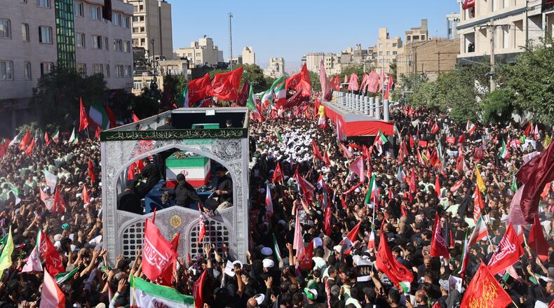 A truck carrying the coffins of the late Iranian Supreme Leader Ayatollah Ali Khamenei and members of his family moves through a main avenue lined with thousands of mourners during the final stage of funeral ceremonies in Mashhad, northeastern Iran, Thursday, July 9, 2026. (Mohammad Hasan Salavati/Shahraranews via AP)