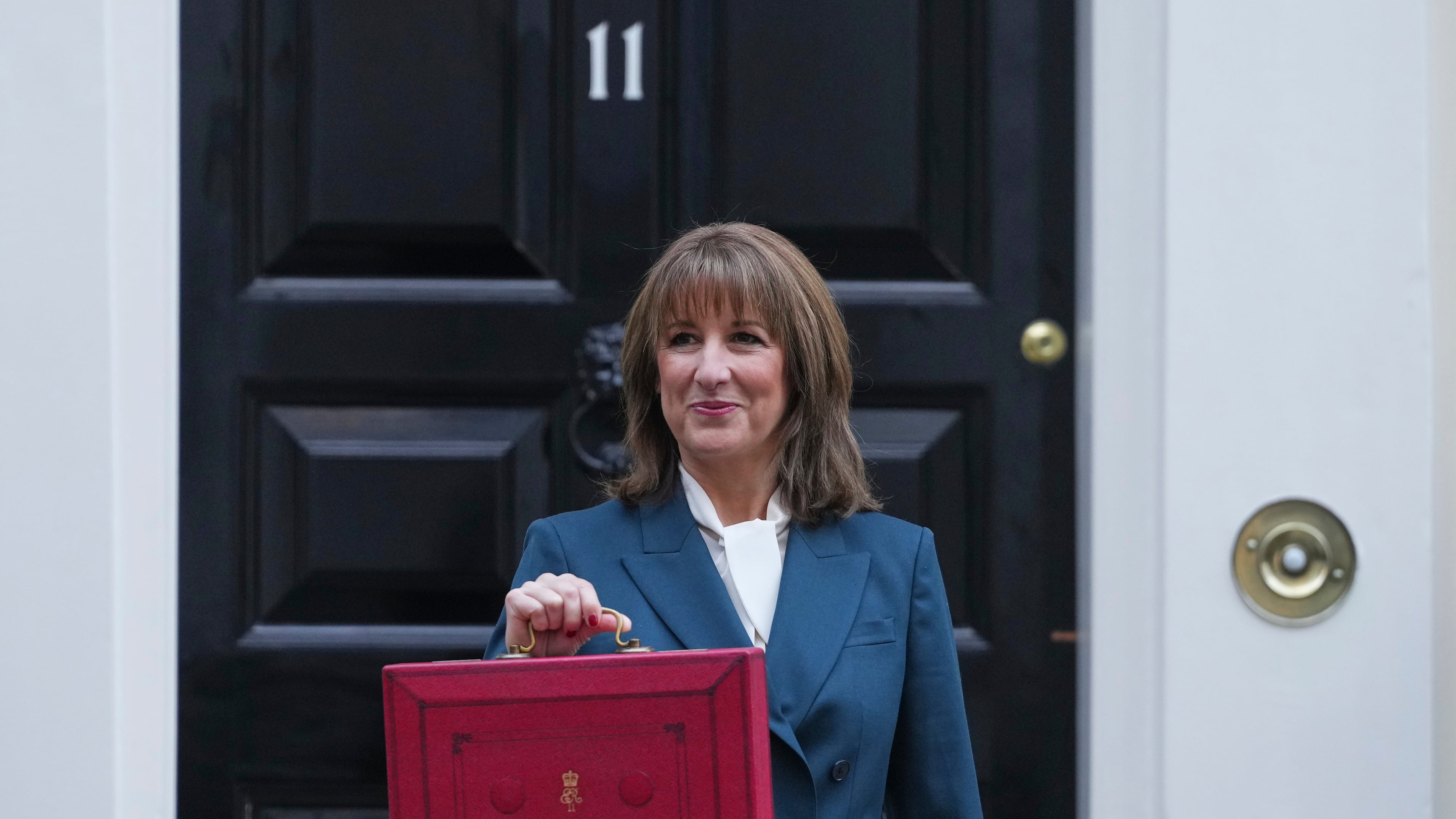 Britain's Chancellor of the Exchequer Rachel Reeves poses on the doorstep of 11 Downing Street with her ministerial red box before heading to the House of Commons to deliver her Budget speech in London, Wednesday, Nov. 26, 2025. (AP Photo/Kirsty Wigglesworth)
