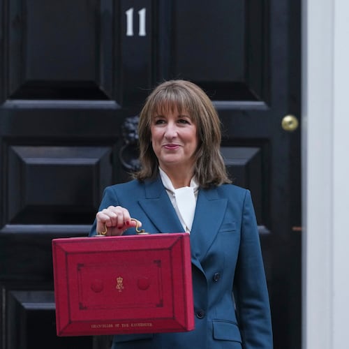 Britain's Chancellor of the Exchequer Rachel Reeves poses on the doorstep of 11 Downing Street with her ministerial red box before heading to the House of Commons to deliver her Budget speech in London, Wednesday, Nov. 26, 2025. (AP Photo/Kirsty Wigglesworth)